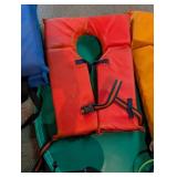 Personal flotation devices and throwable rescue lines