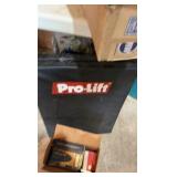 A lot of car supplies, including car wash, pump, and Pro Lift mat.