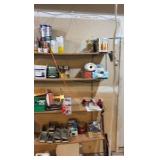 Contents of wooden shelves, including:- various paints- gloss trim- Wheaties box- board games- decorative outdoor lighting- tools- vacuum- mini shop back