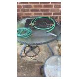 Two outdoor glass tabletop tables, one side table, one full table, and umbrella stand.
