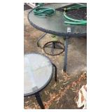 Two outdoor glass tabletop tables, one side table, one full table, and umbrella stand.