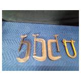 3 large metal clamps and a clevis hitch