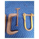 3 large metal clamps and a clevis hitch