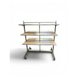 retail merchandising island gondola display unit featuring a chrome steel frame and wood-finished shelving