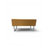 Esto soft seating bench features a unique two-tone design with a patterned yellow back and an orange seat Retails for $1200