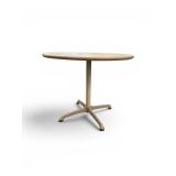 Steelcase bistro table featuring a light-colored laminate top and a beige four-star pedestal base