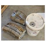 bucket of sand with two bags