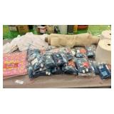 brand new bags of fabric, paint, paper towels, fabric, and letter stamps