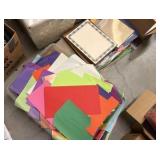 construction paper, various new packs of paper, tissue paper, and clear bags
