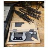 shelf of welding supplies and measuring instruments