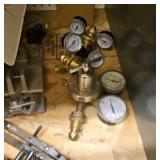 shelf of welding supplies and measuring instruments