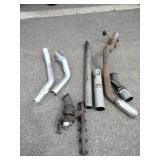 Exhaust manifold with a turbocharger attached, along with various 4" straight and bent pipes, a muffler or resonator, and a tailpipe tip.