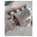 Exhaust manifold with a turbocharger attached, along with various 4" straight and bent pipes, a muffler or resonator, and a tailpipe tip.