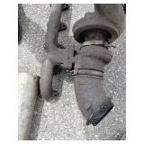 Exhaust manifold with a turbocharger attached, along with various 4" straight and bent pipes, a muffler or resonator, and a tailpipe tip.