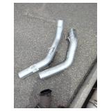 Exhaust manifold with a turbocharger attached, along with various 4" straight and bent pipes, a muffler or resonator, and a tailpipe tip.