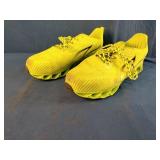 These fluorescent yellow running sneakers feature a distinct blade-style cushioned sole and breathable mesh upper. Size 13