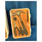 Collection of household hand tools, a cordless drill, and various wall anchors, screws, and nails organized