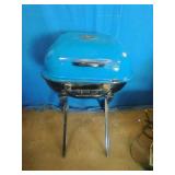 Americana Walk-A-Bout portable charcoal grill in blue.