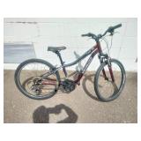 Maroon Specialized Hotrock 24 mountain bike with 24-inch wheels.