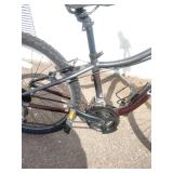 Maroon Specialized Hotrock 24 mountain bike with 24-inch wheels.