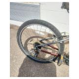 Maroon Specialized Hotrock 24 mountain bike with 24-inch wheels.