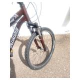 Maroon Specialized Hotrock 24 mountain bike with 24-inch wheels.