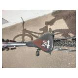 Maroon Specialized Hotrock 24 mountain bike with 24-inch wheels.