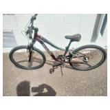 Maroon Specialized Hotrock 24 mountain bike with 24-inch wheels.