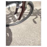 Maroon Specialized Hotrock 24 mountain bike with 24-inch wheels.