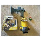 Despicable Me Themed Lot: Minion Piggy Bank, Light-up Fart Gun, Dressed Minion Figurine, and Activity Pack