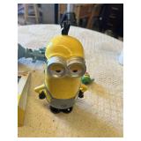 Despicable Me Themed Lot: Minion Piggy Bank, Light-up Fart Gun, Dressed Minion Figurine, and Activity Pack