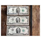 Three United States $2 bills Two are from the 1976 series, and one is from the 2009 series