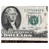 Three United States $2 bills Two are from the 1976 series, and one is from the 2009 series