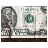 Three United States $2 bills Two are from the 1976 series, and one is from the 2009 series