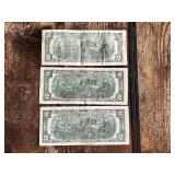 Three United States $2 bills Two are from the 1976 series, and one is from the 2009 series