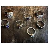 Vintage and costume ring collection including multi-stone band, solitaire rings, and gemstone accents