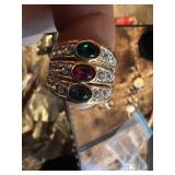 Vintage and costume ring collection including multi-stone band, solitaire rings, and gemstone accents