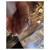 Vintage and costume ring collection including multi-stone band, solitaire rings, and gemstone accents