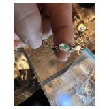 Vintage and costume ring collection including multi-stone band, solitaire rings, and gemstone accents