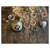 Lot of various silver and gold rings, including ornate designs and a large decorative shield-style ring and wolf insignia ring
