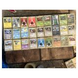 Lot of 54 Pokemon Trading Cards including Energies, Trainers, and Pokemon Characters.