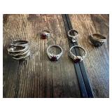 Rings with various designs including some with red stones and geometric patterns