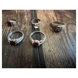 Rings with various designs including some with red stones and geometric patterns
