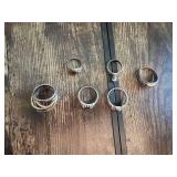 Rings with various designs including some with red stones and geometric patterns