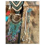 Collection of beaded necklaces and rosaries including multicolored designs