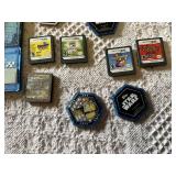Old Nintendo, Nintendo DS, and PS2 video games, memory cards, and Star Wars collectible pieces including The Penguins Madagascar, Ben 10, and Mario Hoops 3-on-3.