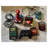 Electronic Games and Controllers Assortment including SteelSeries Controller, Various Handheld Electronic Games, and Spiderman Plug-and-Play Joystick