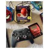 Electronic Games and Controllers Assortment including SteelSeries Controller, Various Handheld Electronic Games, and Spiderman Plug-and-Play Joystick