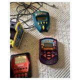 Electronic Games and Controllers Assortment including SteelSeries Controller, Various Handheld Electronic Games, and Spiderman Plug-and-Play Joystick
