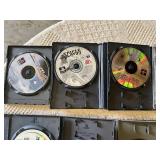 Multiple video games for PlayStation with titles such as Madden 99, Twisted Metal, and NBA Live 10.